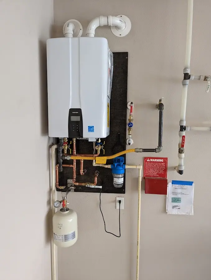 Professional plumber installing copper piping in a Girard home